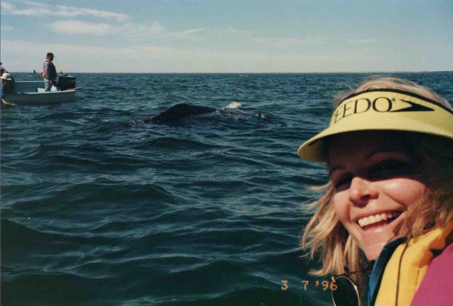 Lori Robinson touching whales in Mexico